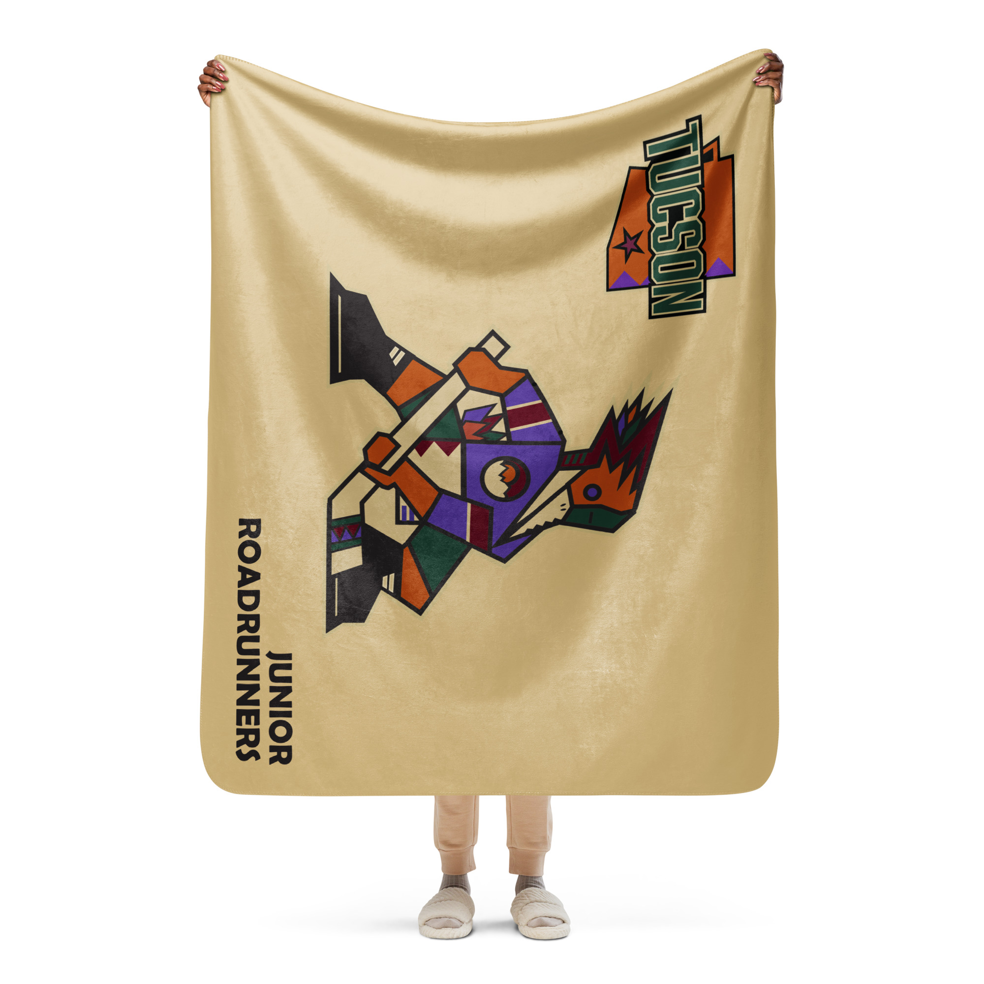 Person holding the 50 x 60 Tucson Junior Roadrunners sand Kachina sherpa blanket